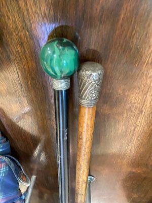two baseball bats sitting on a table next to a bag