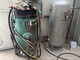 a water heater and a water tank in a garage