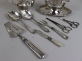 a lot of silverware sitting on a table