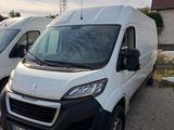 two white vans parked next to each other in a parking lot