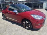 the red citrole is parked in front of a building