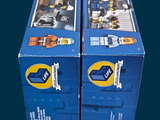 two boxes of legos sitting side by side on a table
