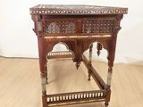a small wooden table with a mirror on top of it