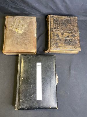 three old books sitting on top of a black table next to each other