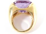 a close up of a gold ring with an amethorate stone