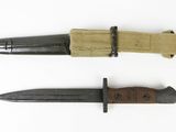 two knifes are laying side by side on a white surface