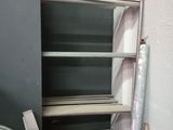 a stack of books on a shelf in the corner of a room