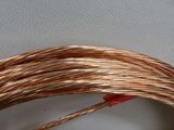 a close up of a coil of copper wire on a white surface