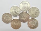 a bunch of coins sitting on top of a white surface