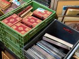 a lot of boxes and crates of records on the floor