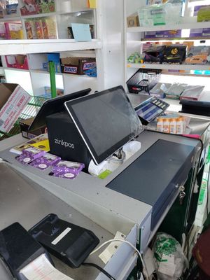 a cash register in a store with a lot of items