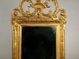 an ornate gold framed mirror with a black background