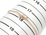 a close up of a measuring tape with a gold ring on it