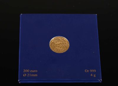 a close up of a blue box with a gold coin on it