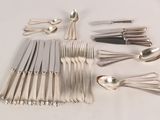 a lot of silver spoons and forks on the table