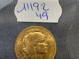 a close up of a gold coin with a label on it