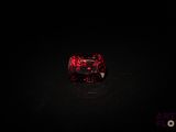 un gros plan sur un diamant rouge dans l'obscurité