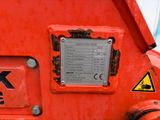 a close up of a red machine with a sign on it
