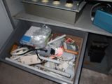 a drawer full of assorted items in a room