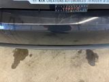 a car with a sticker on the back of it ' s bumper