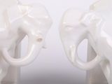 two white elephants that are standing next to each other