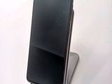 a cell phone that is sitting on top of a stand