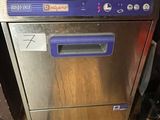 stainless steel dishwasher sitting on top of a wooden floor in a kitchen