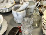 many dishes and cups on a table with a phone on it