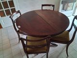 a table with four chairs around it in a room