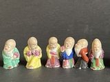 many small figurines that are lined up on a table