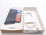 a box with a phone inside of it on a white surface