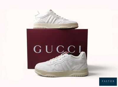 white gucci sneakers with a red box on a white background