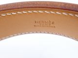 hermes, a brown leather belt with white stitching and a gold buckle