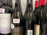 bottles of wine are lined up on a shelf in a store