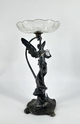 an image of a statue of an angel holding a bird on a stand