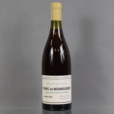 a bottle of wine sitting on top of a table next to a glass