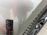 a measuring tape on the side of a car