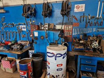 a blue wall with tools on it in a garage