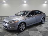an image of a silver ford monde parked in a garage