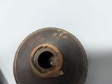 a brown vase sitting on top of a white table