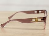 sunglasses on a wooden table with a white wall in the background
