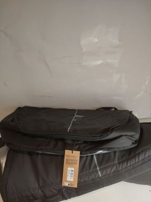 two pieces of luggage sitting on top of each other on a table