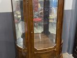 a wooden display case with glass doors in a room