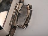 a close up of a silver watch on a white surface
