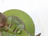 a close up view of a green propanent on a white surface