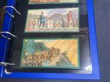 a blue binder with three pictures of people on it