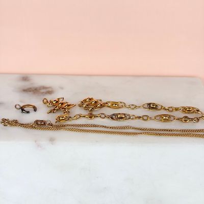 a close up of a marble slab with a bunch of jewelry on it