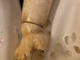 a close up of a doll with a dress on