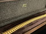 a box with a gold chain on the inside of it