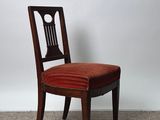 an image of a wooden chair with a red upholstered seat